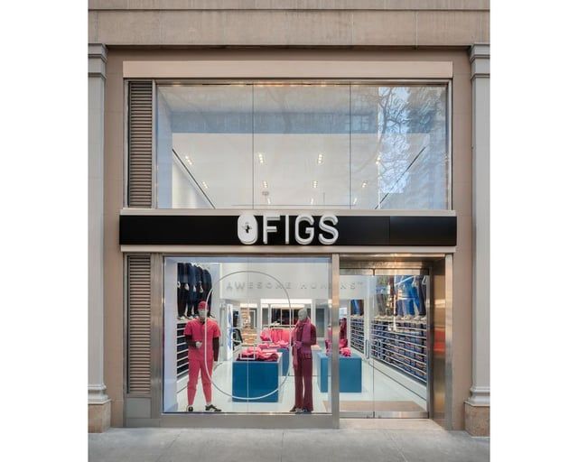 A blurry picture of a clothing store with clothes on display.