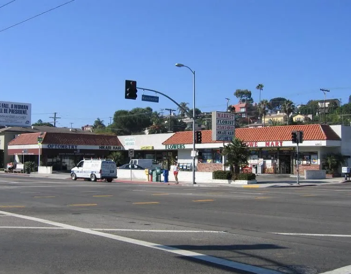 A white van is parked on the side of the road