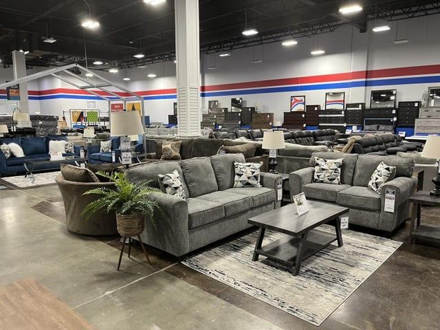 A living room filled with furniture in a furniture store.