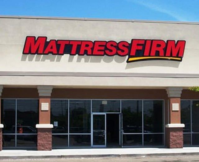 The front of a mattress firm store with lots of windows