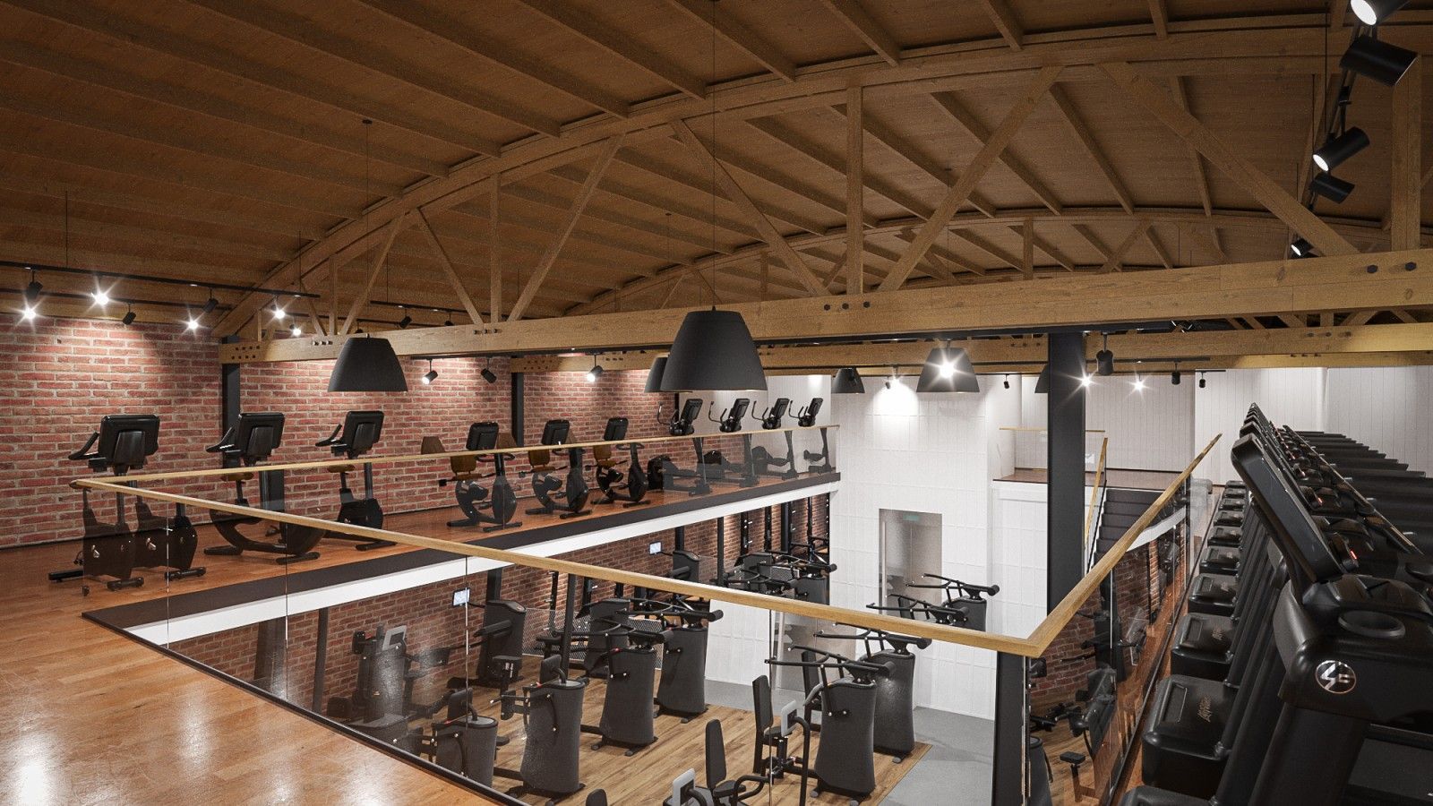 A gym with a lot of exercise equipment and a wooden ceiling.