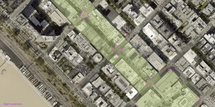 A blurred image of a city street with people walking down it.