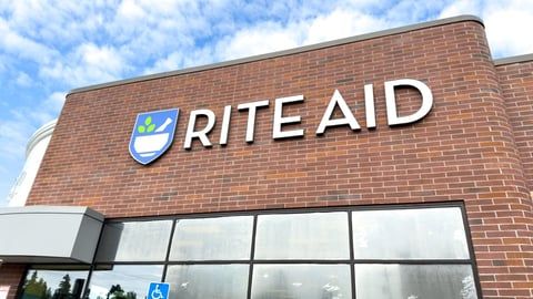 The front of a rite aid store with a sign on it.