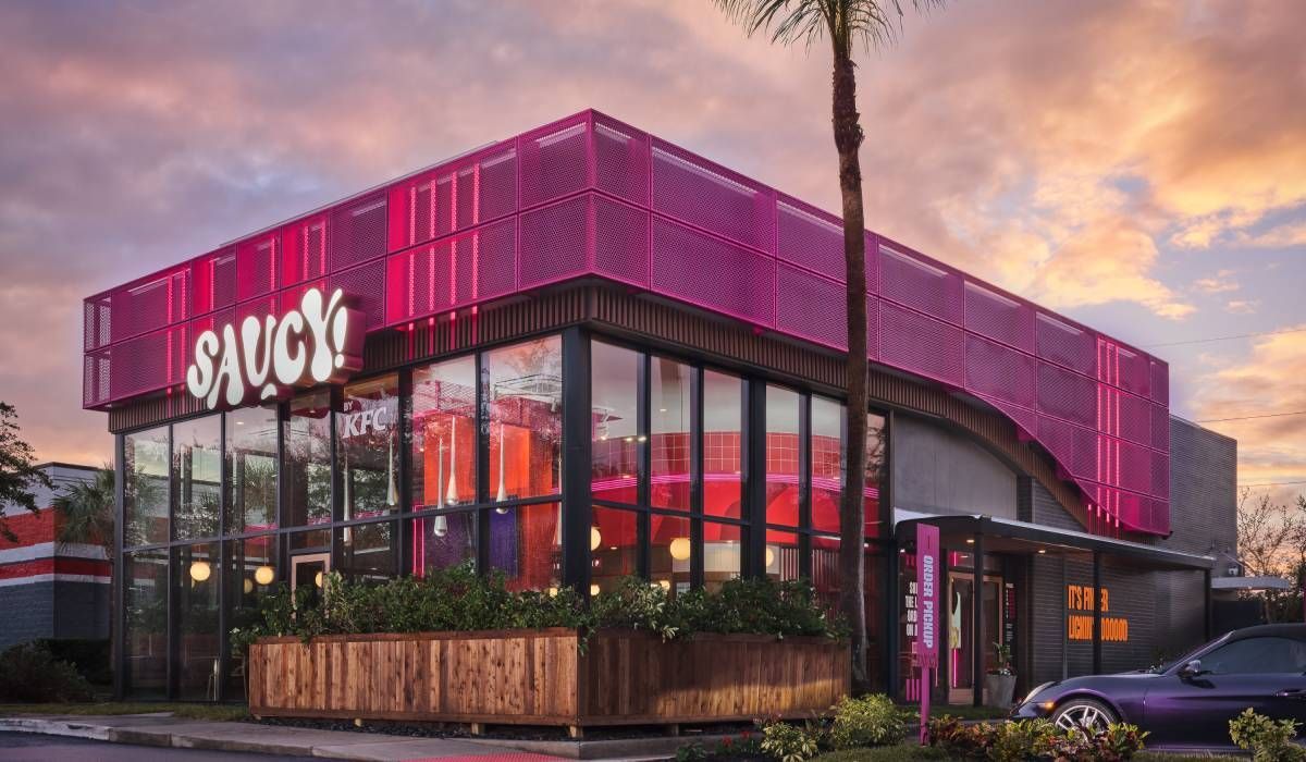 A purple car is parked in front of a sauce restaurant.
