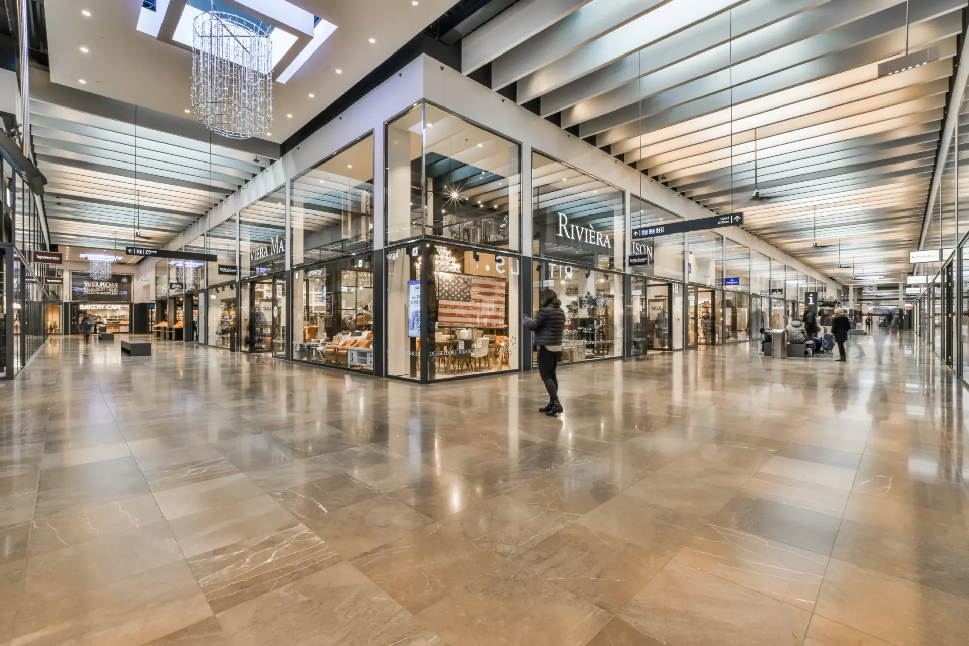 The front of an aldi store with a sign in front of it.