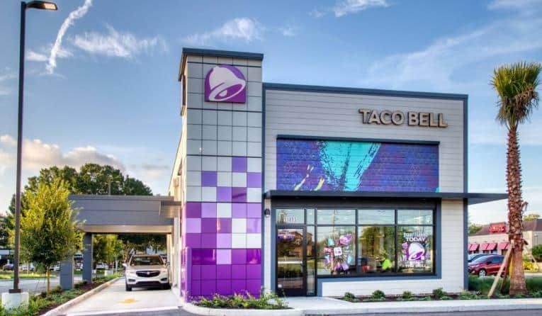 A car is parked in front of a sign that says 223