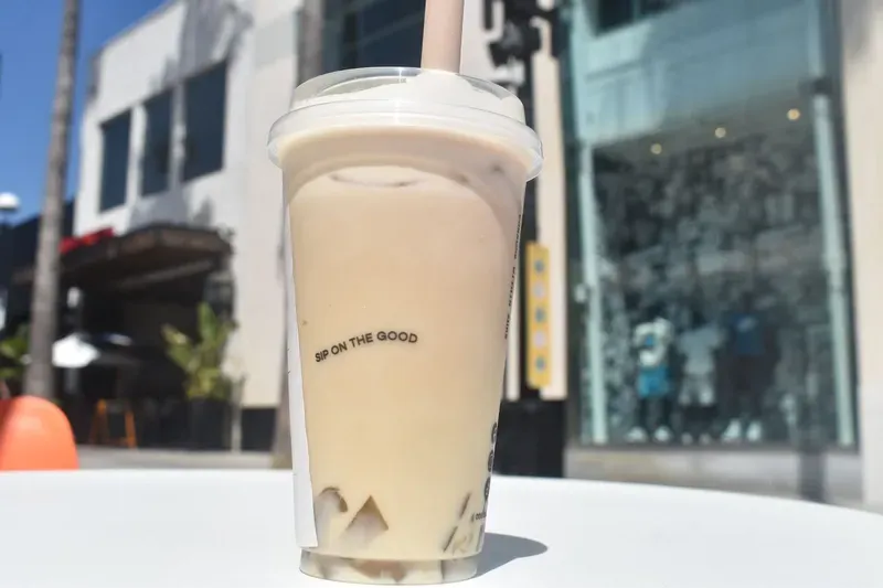 A cup of bubble tea with a straw on a table.