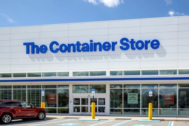 A car is parked in front of the container store