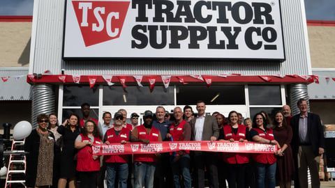 A car is parked in front of a sign that says 223