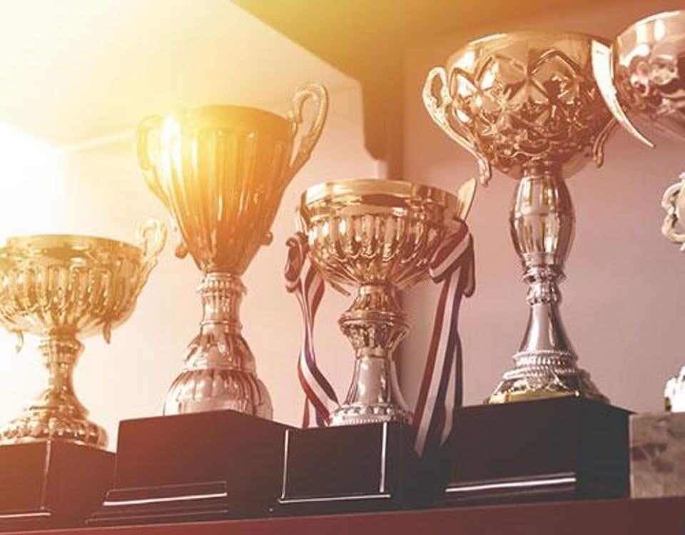 Interior of a casual restaurant featuring blue chairs, red accents, brick walls, and a 