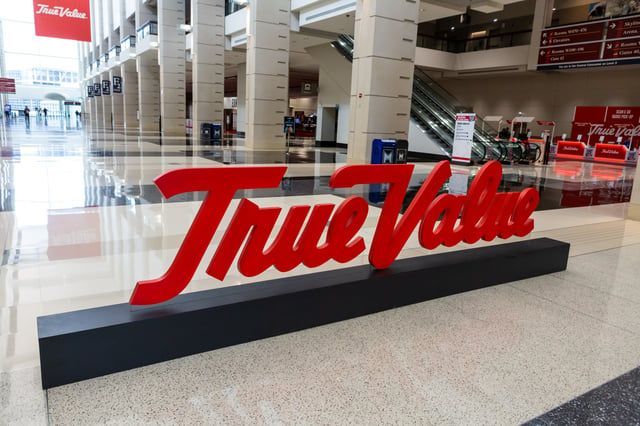 A large red true value sign in a building