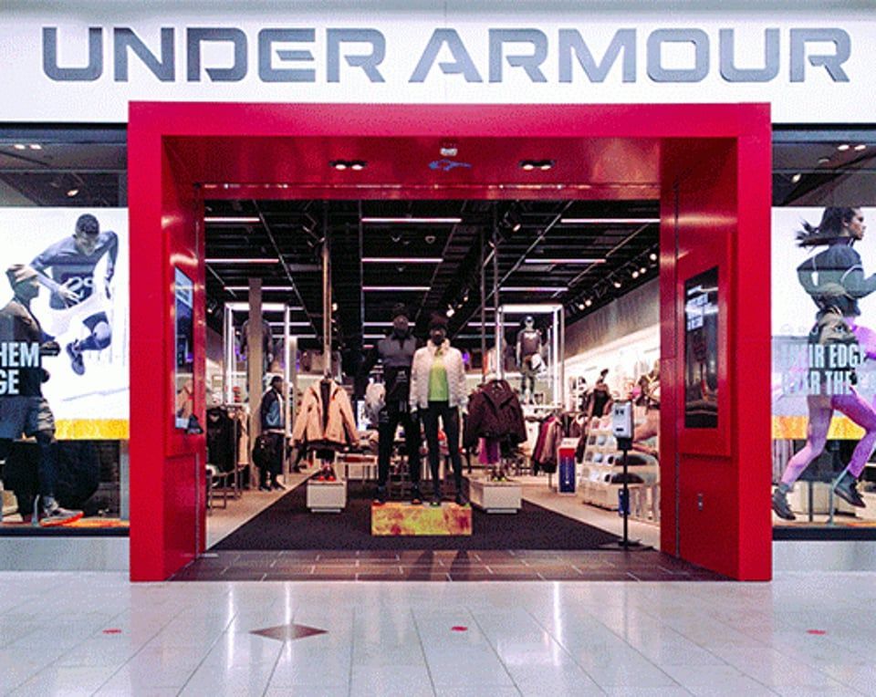 A blurred image of a city street with people walking down it.