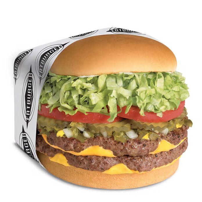 A double cheeseburger with lettuce tomato and pickles