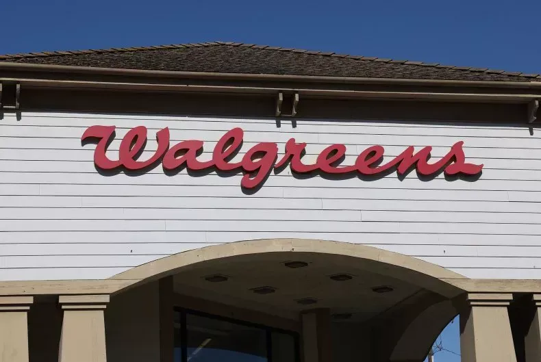 The front of a walgreens store with a blue sky in the background