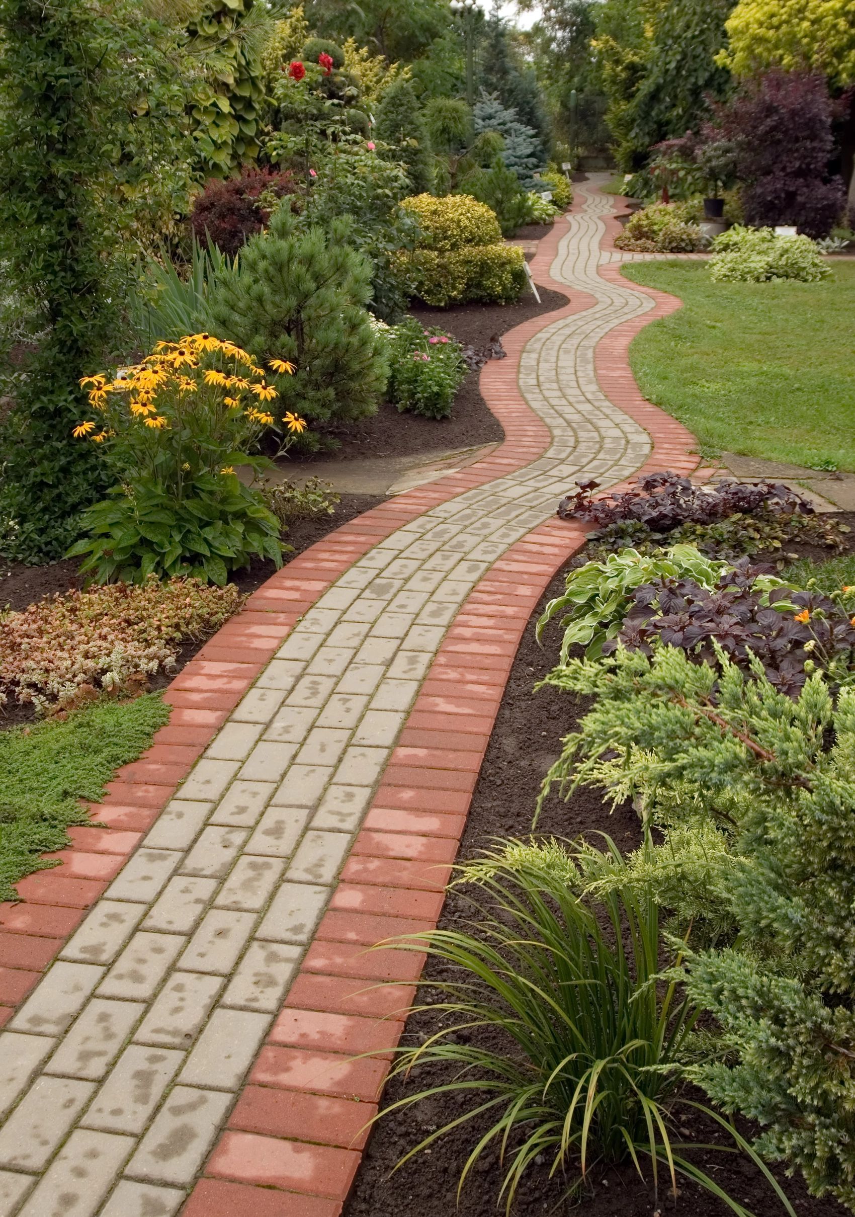 custom concrete paver pathway through a garden