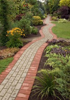 curving paver walking path thru a garden