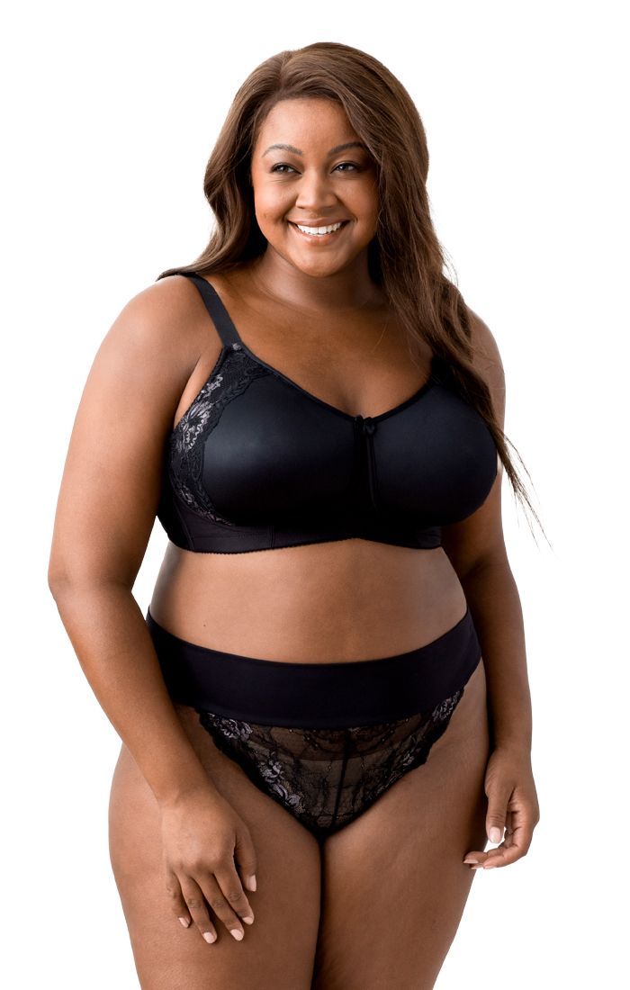 A plus size woman is wearing a black bra and underwear.