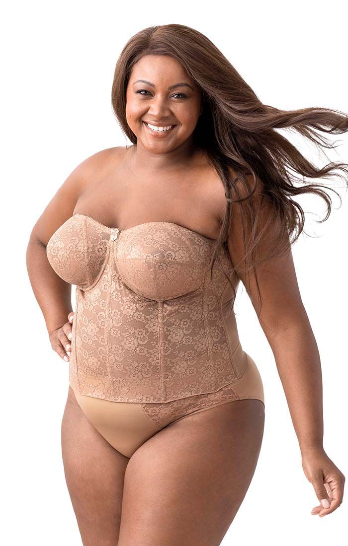 A plus size woman is wearing a strapless corset and underwear.