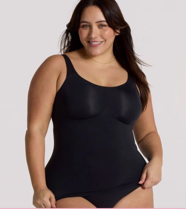 A woman is wearing a black tank top and black underwear