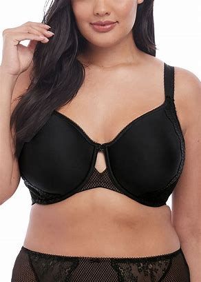 A woman is wearing a black bra and black underwear.