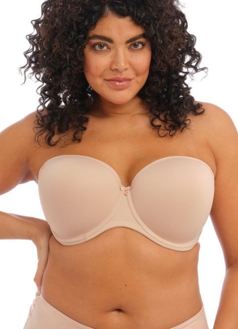 A woman with curly hair is wearing a strapless bra