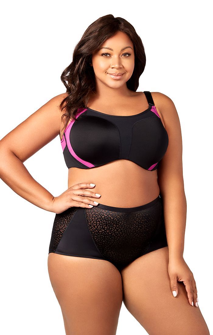 A plus size woman is wearing a black bra and black underwear.