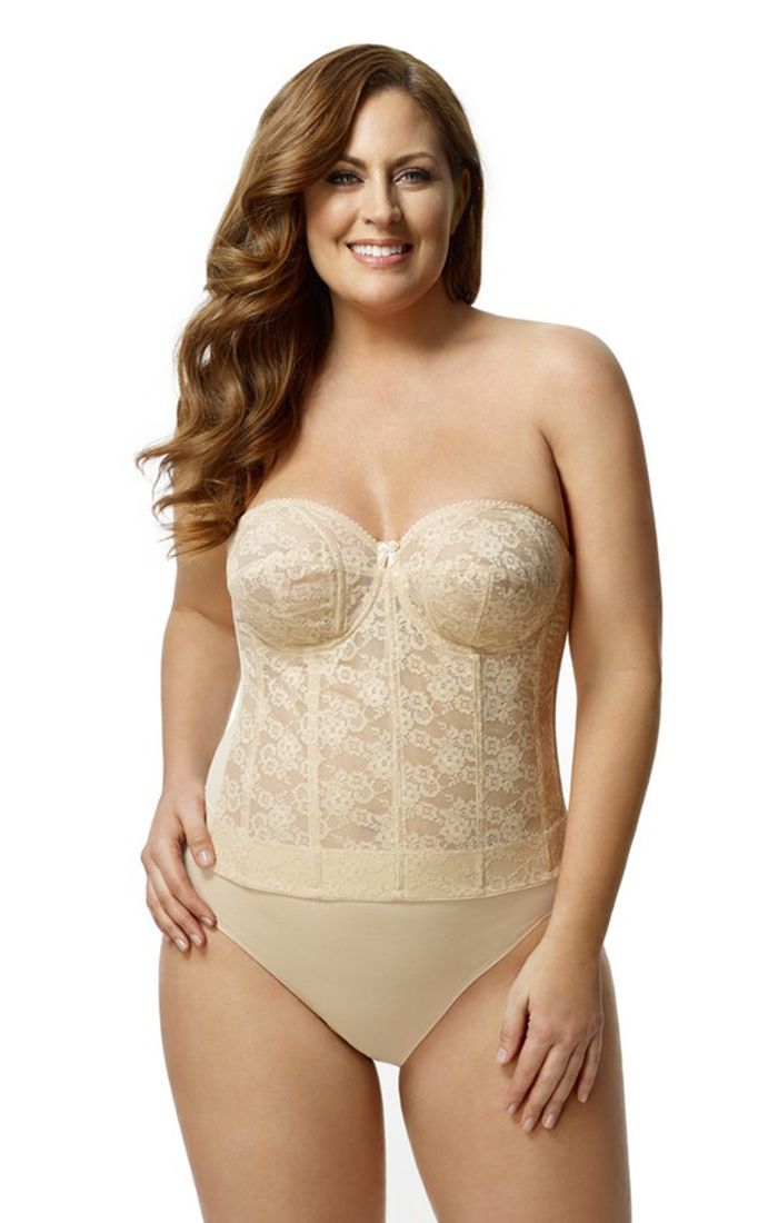 A plus size woman is wearing a strapless corset and underwear.