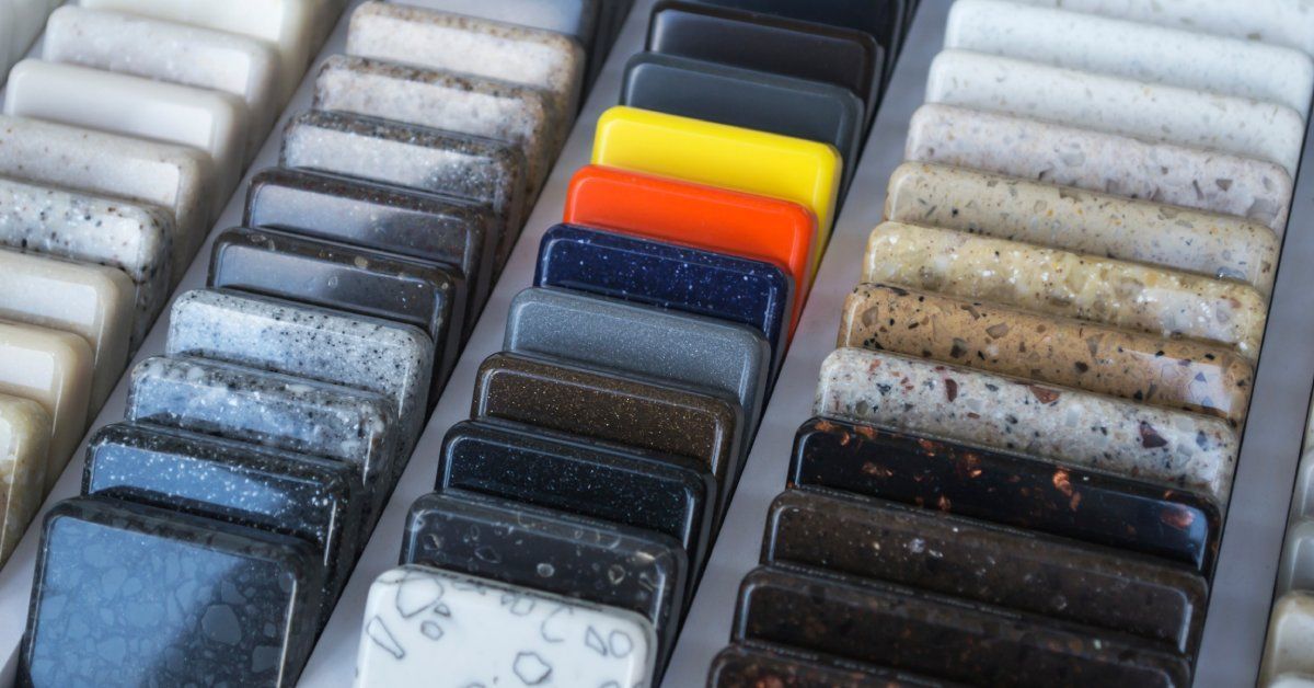 Six rows of small countertop samples that include granite, quartz, and marble.