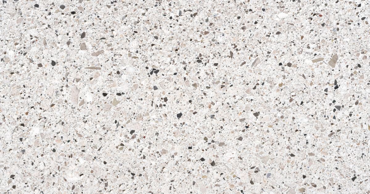 A huge piece of quartz for a countertop. The stone countertop is white with multi-colored flecks in it.