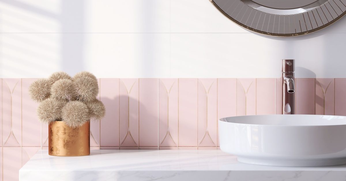 A white bathroom vanity with a sink and a small potted plant on it. Sunshine is washing over.