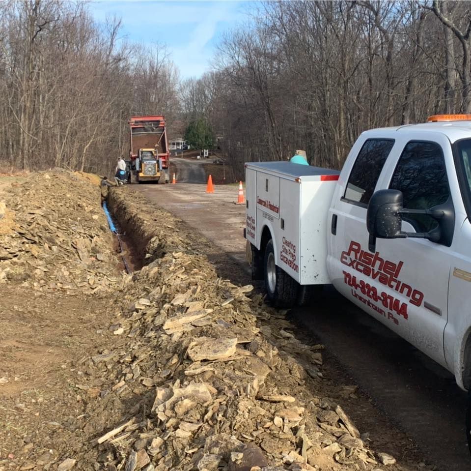A white truck with the word excavating on it