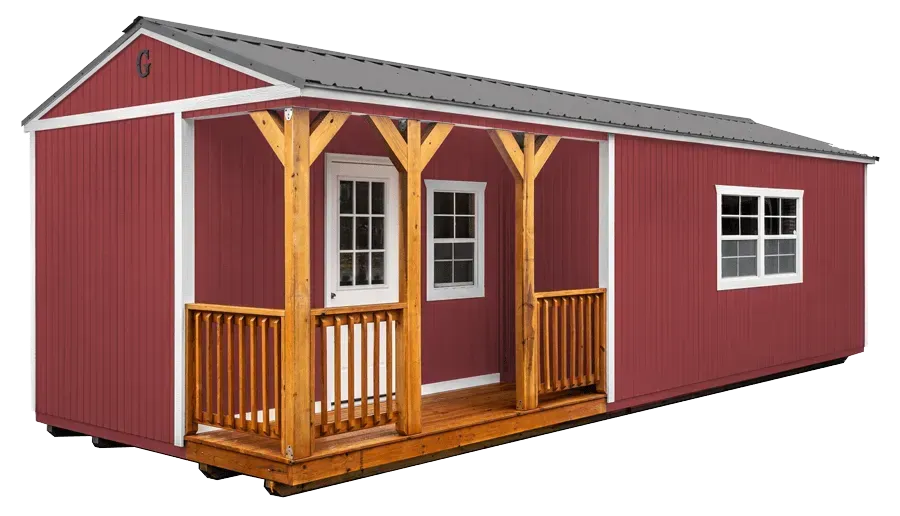 Red cabin with wooden porch, white trim, and gray roof.