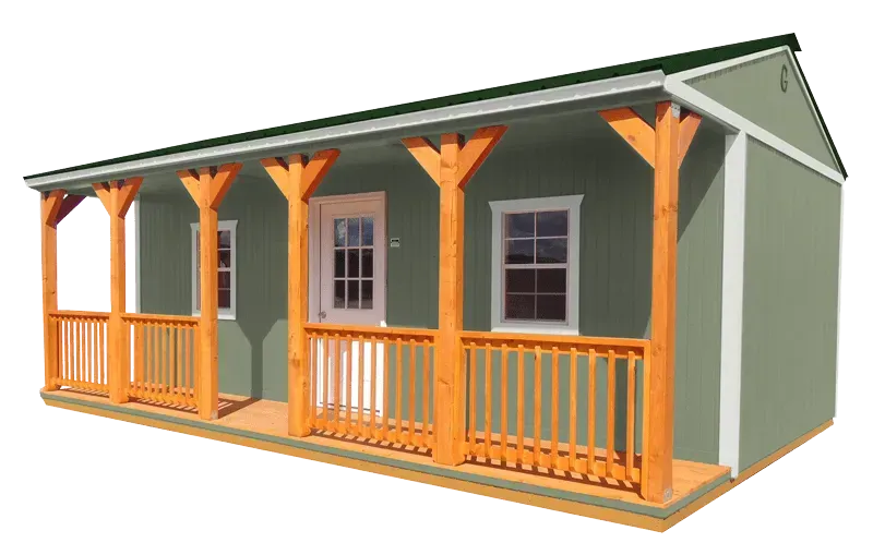 Green cabin with wooden porch and railing.
