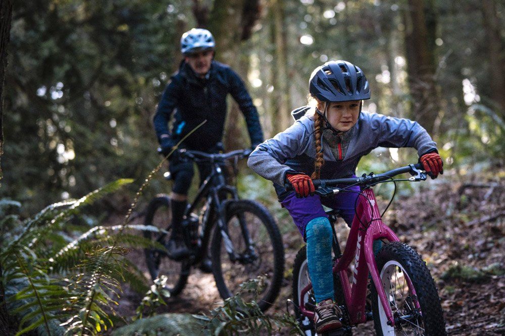 Young girl using a Trek Kids Bikes in the forrest