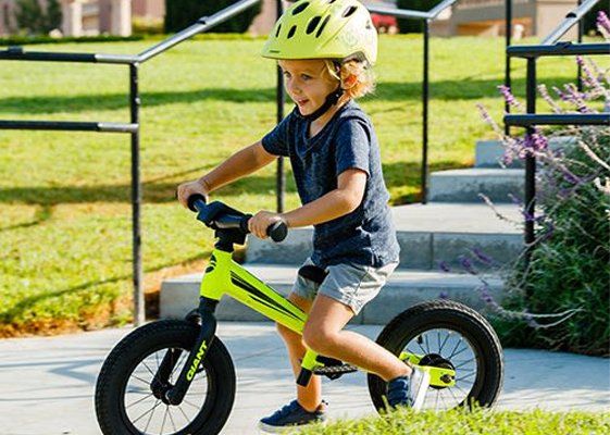 A child using a Giant Yellow Kids Bike