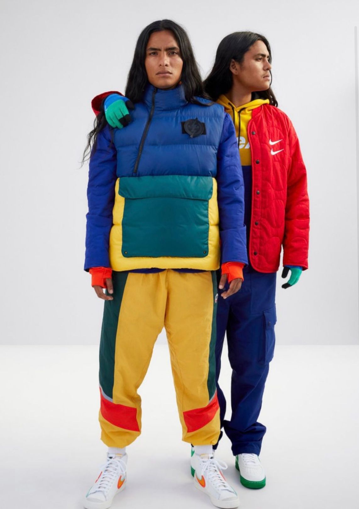 Two people in colorful Nike athletic wear pose against a white backdrop.