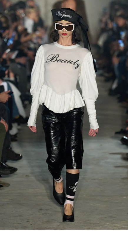 Fashion model wearing a white top with 