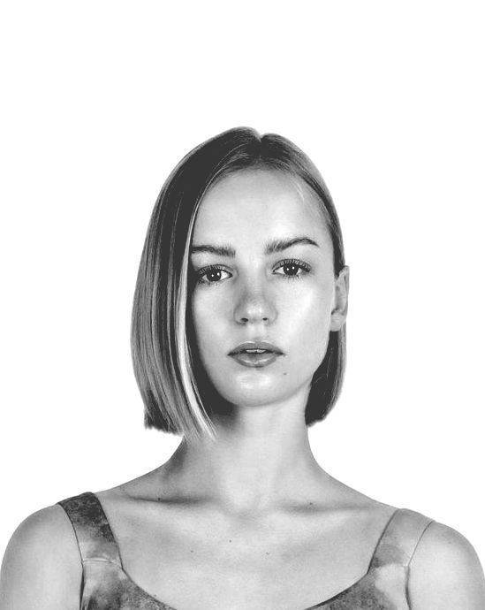 Woman with short, straight, light-colored hair, looking directly at the viewer. Black and white.