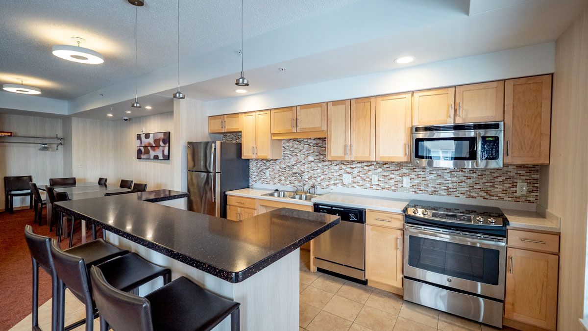 A kitchen with stainless steel appliances and wooden cabinets