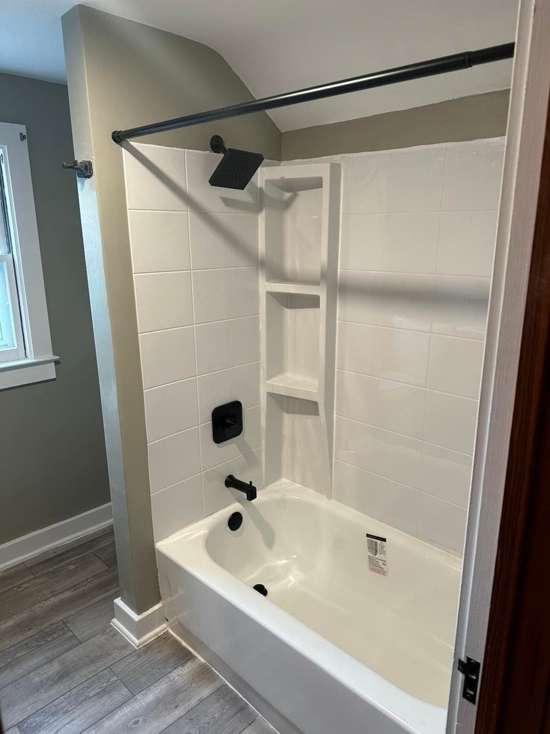 A bathroom with a bathtub and a shower.