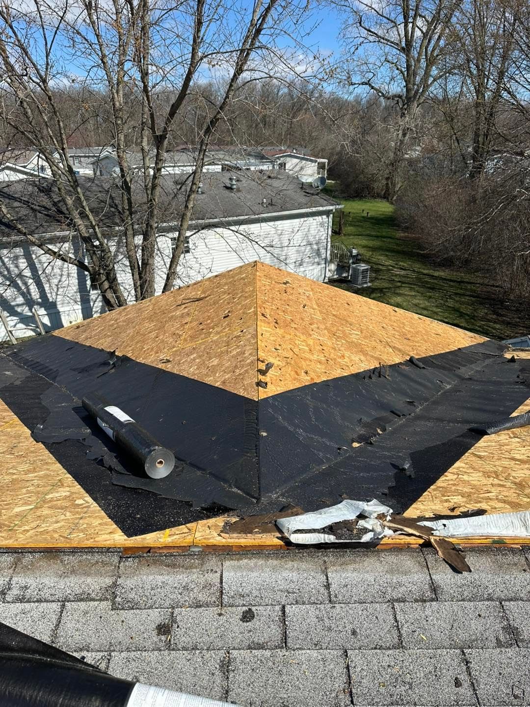 A roof with a pyramid shaped roof being built on it.