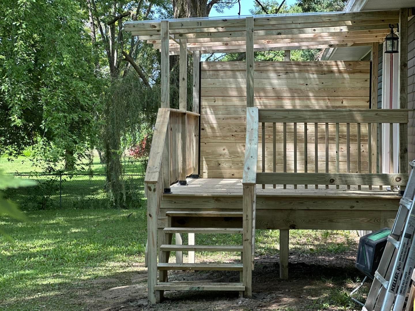 A wooden deck with stairs leading up to it