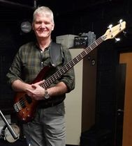 Photo of Neil Jones playing the Bass guitar.