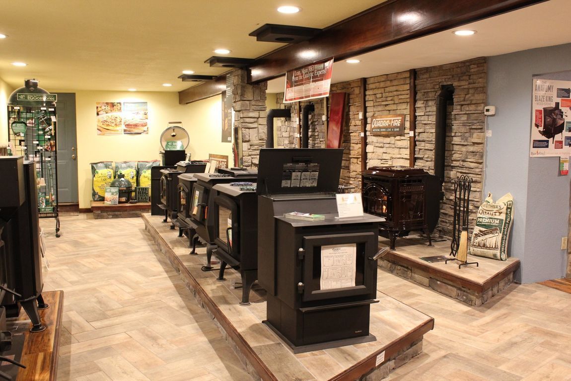 A showroom filled with lots of stoves and fireplaces.