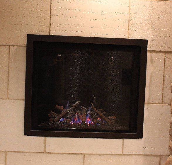 A fireplace is built into a white tiled wall