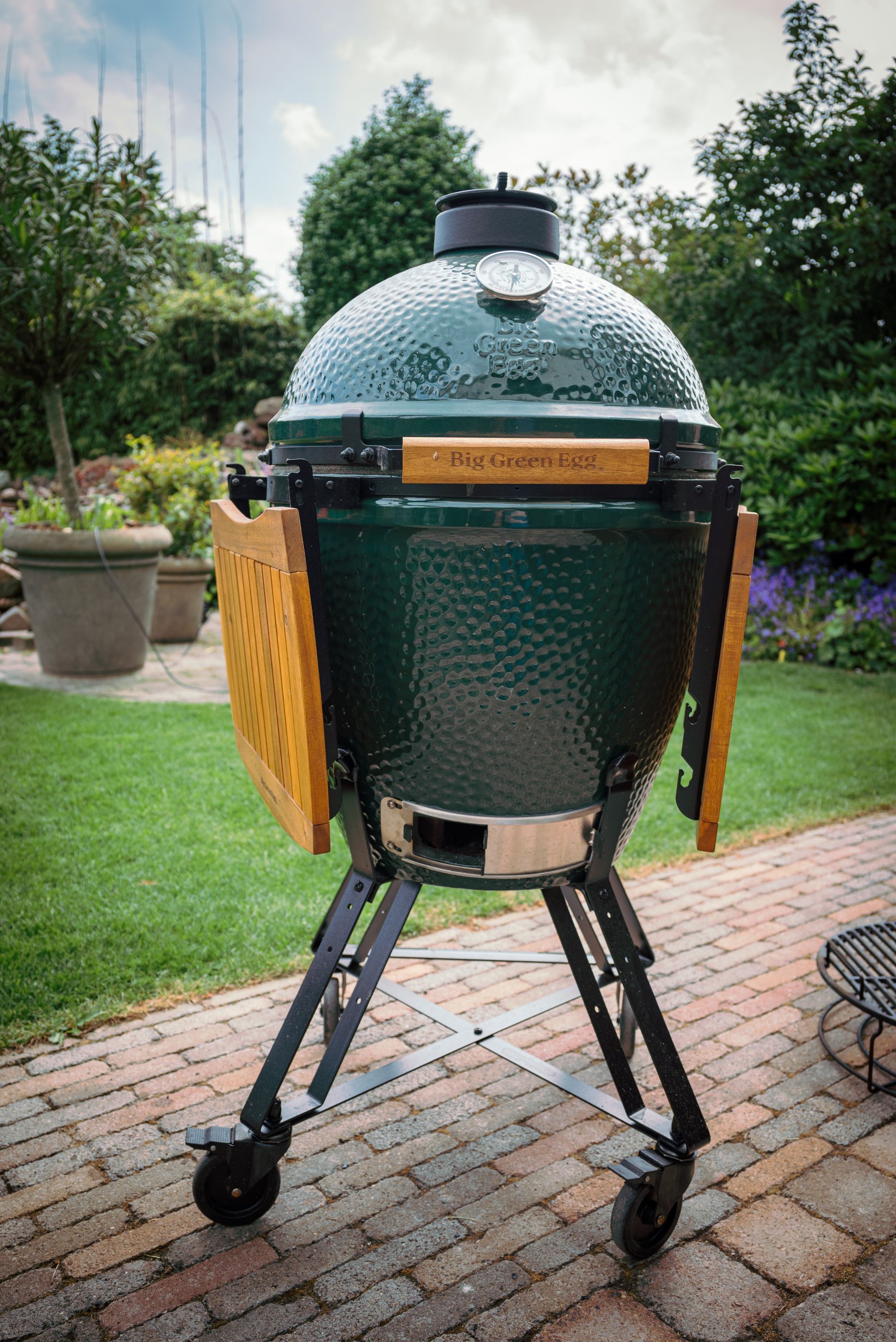 A barbecue is being cooked on a grill in a park.