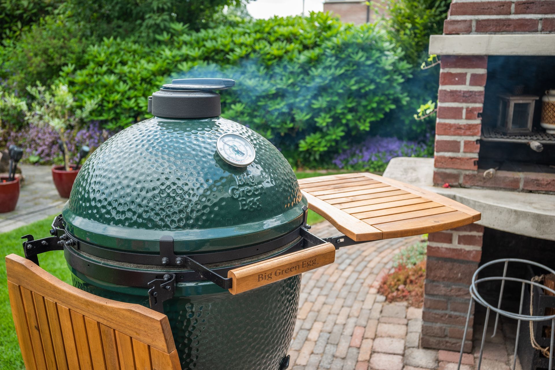 There is a grill and umbrella on the deck.
