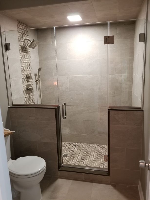 A bathroom with a toilet and a walk in shower.