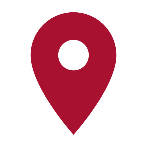 A red map pin with a white circle in the middle.