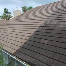 A picture of a roof before and after being cleaned.